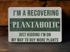 a sign that says i'm a recovering plantaholic just kidding i