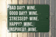 a green sign that says bad day? wine good day? wine stressed?