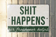 a sign that says shit happens air freshener helps