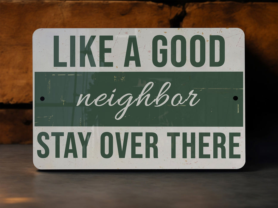 a green and white sign that says like a good neighbor stay over there