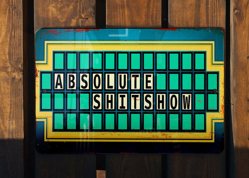 a sign on a wooden fence that says absolute shit show