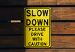 a yellow slow down sign on a wooden wall