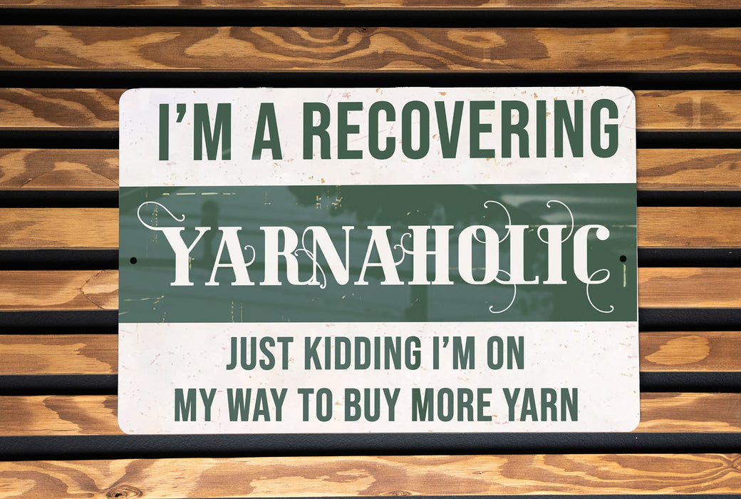 a green and white sign that says i'm a recovering yarnaholic