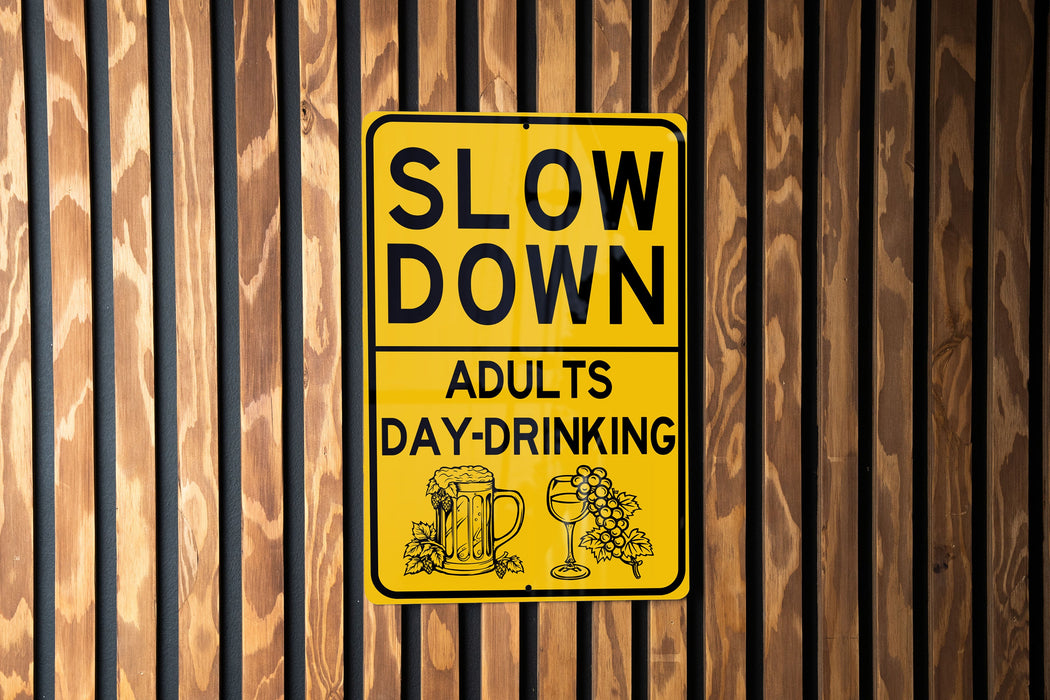 a yellow slow down sign on a wooden wall