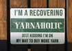 a green and white sign that says i'm a recovering yarnaholic
