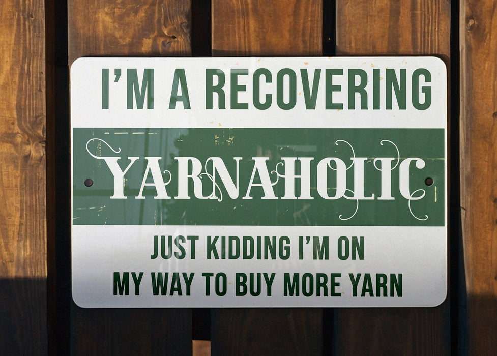 a green and white sign that says i'm a recovering yarnaholic