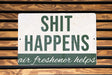 a sign that says shit happens air freshener helps