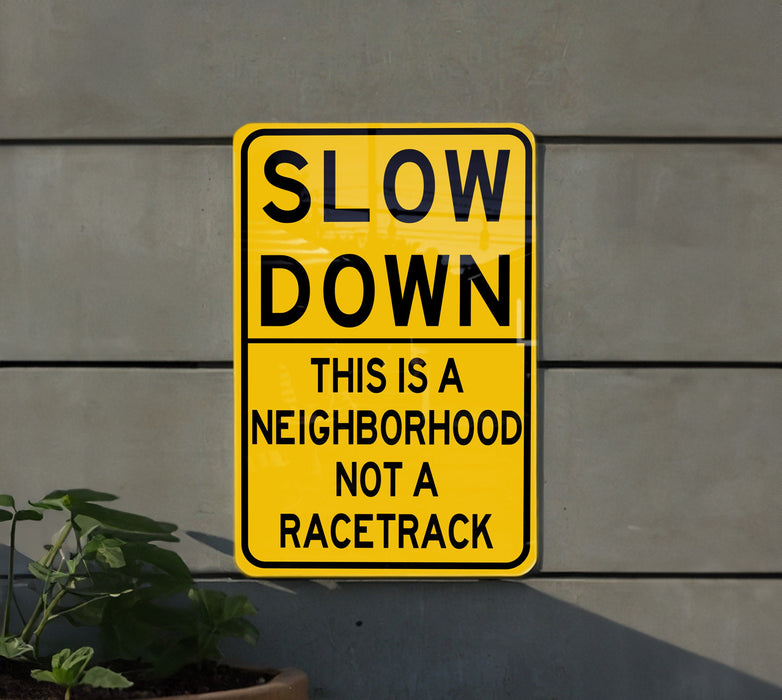 a yellow slow down sign on the side of a building