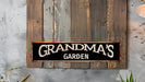a sign that says grandma's garden hanging on a wall