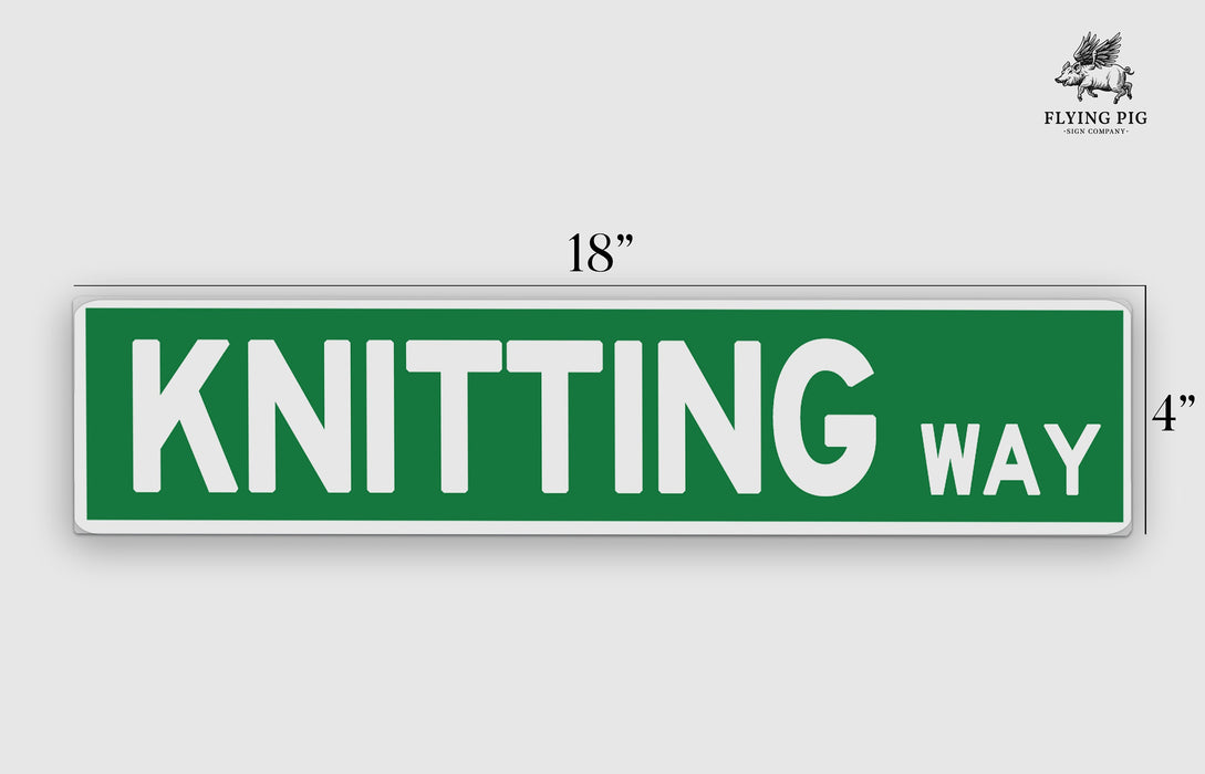 a green and white street sign that says knitting way