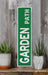 a green sign sitting on top of a wooden shelf