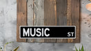 a black and white music street sign mounted to a wooden wall