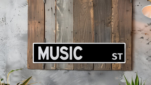 a black and white music street sign mounted to a wooden wall