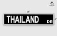 a black and white street sign that says thailand