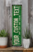 a green sign sitting on top of a wooden shelf