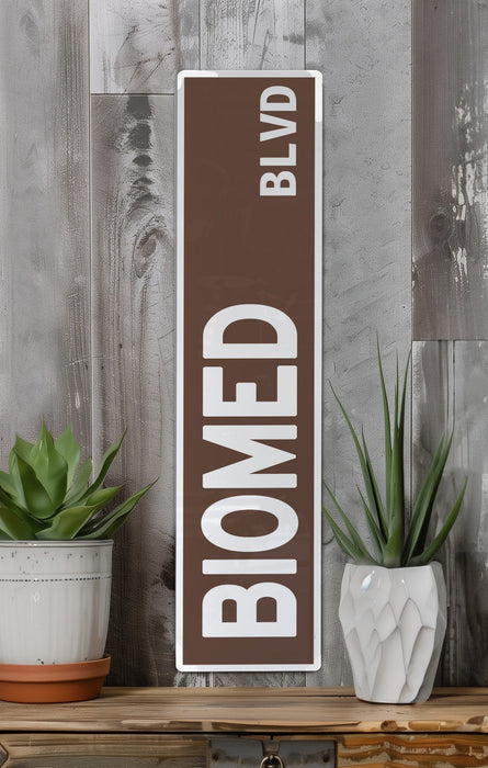 a brown and white sign sitting on top of a wooden shelf