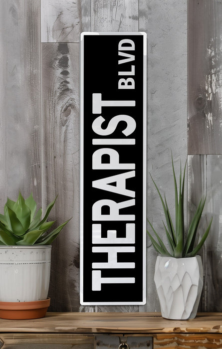 a black and white sign sitting on top of a wooden shelf