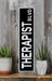 a black and white sign sitting on top of a wooden shelf