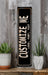 a black and white sign sitting on top of a wooden shelf
