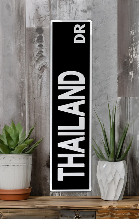 a black and white sign sitting on top of a wooden shelf