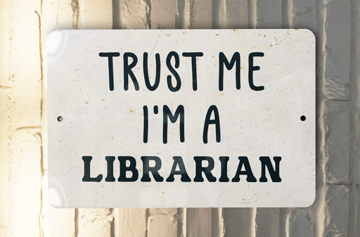 a white sign that says trust me i'm a librarian