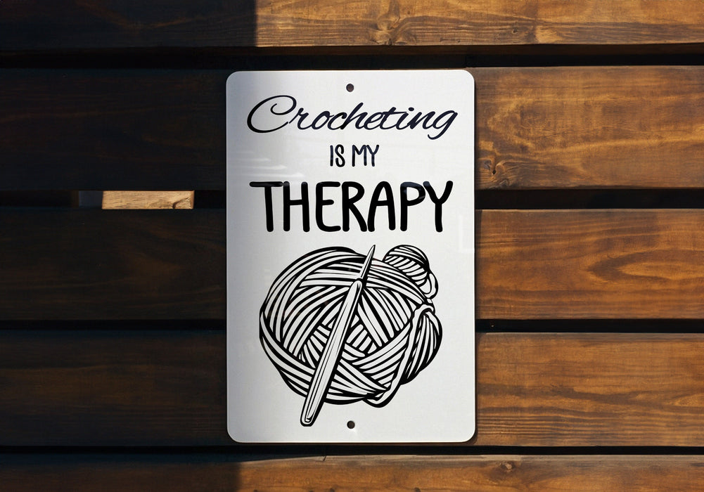 a sign that says crocheting is my therapy