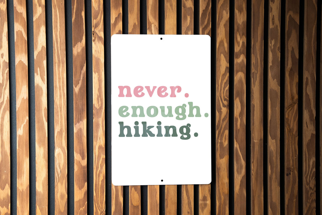 a sign on a wooden wall that says never, enough hiking