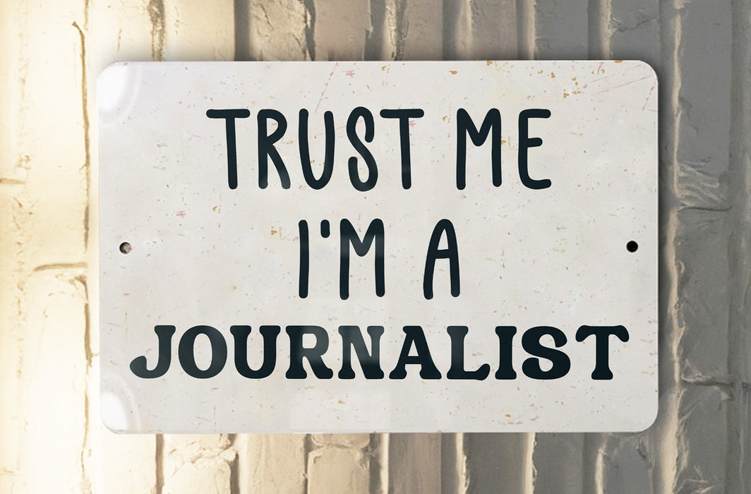 a white sign that says trust me i'm a journalist