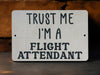 a sign that says trust me i'm a flight attendant
