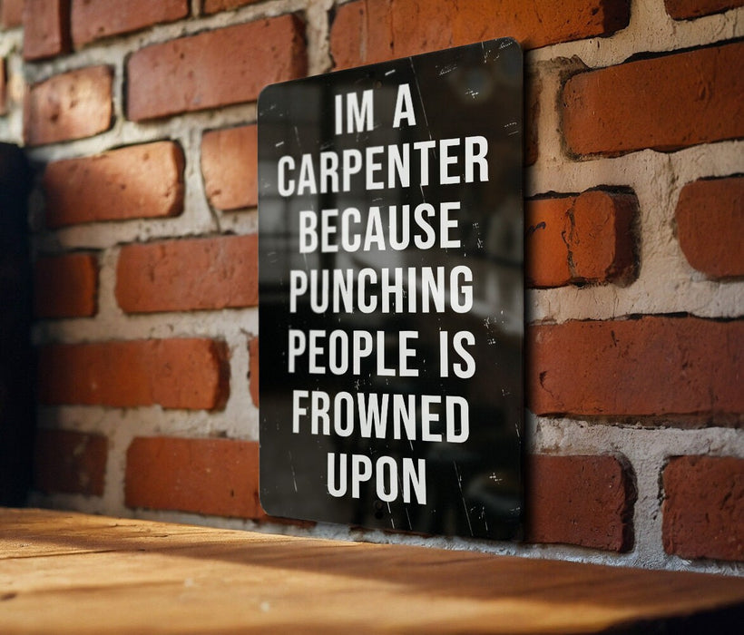 a sign on a brick wall that says i'm a carpenter because punching people