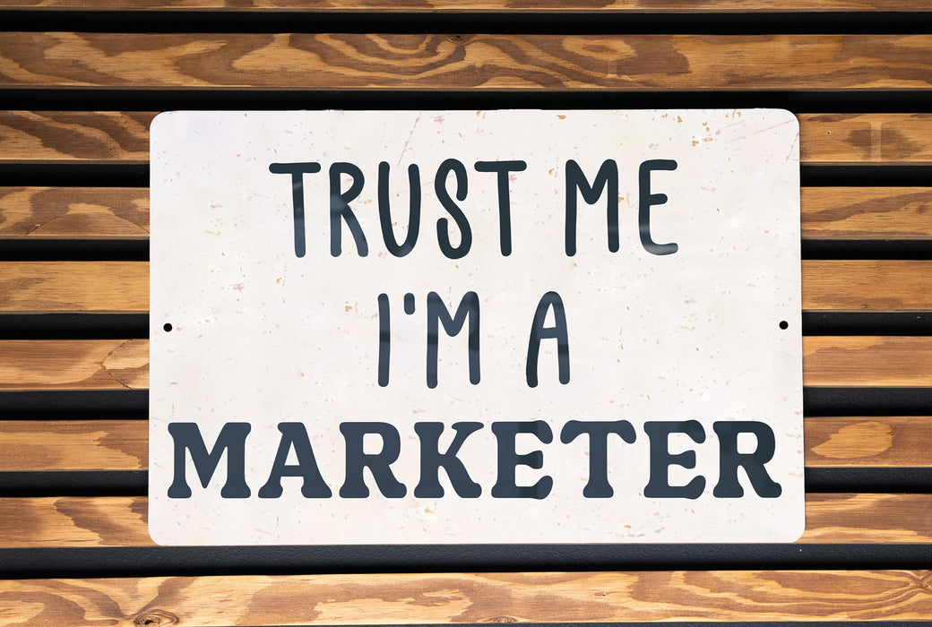 a sign that says trust me i'm a marketer