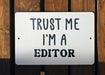a white sign that says trust me i'm a editor