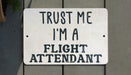 a sign that says trust me i'm a flight attendant