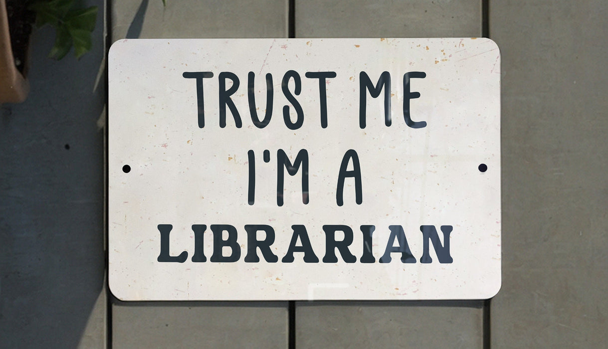 a white sign that says trust me i'm a librarian