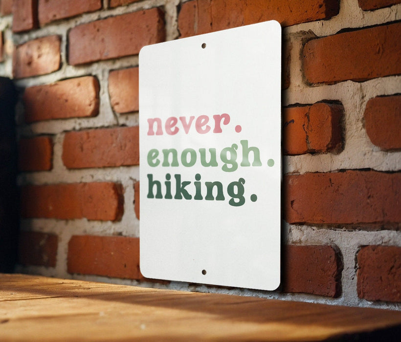 a sign on a brick wall that says never enough hiking