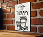 a sign on a brick wall that says coffee is my therapy