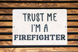 a sign that says trust me i'm a firefighter