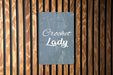 a sign on a wooden wall that says crocket lady