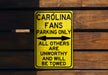 a yellow parking only sign hanging on a wooden wall
