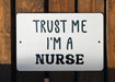 a white sign that says trust me i'm a nurse