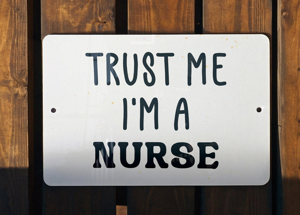 a white sign that says trust me i'm a nurse