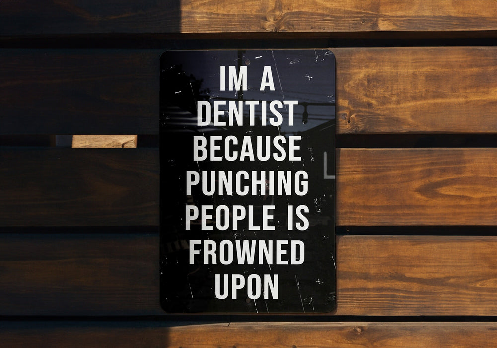 a sign on a wooden bench that says i'm a dentist because punching people