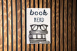 a book nerd sign on a wooden wall