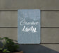 a sign that reads crochet lady next to a potted plant