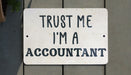 a white sign that says trust me i'm a accountant