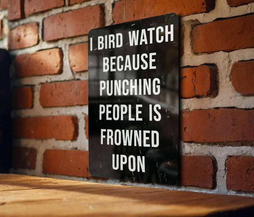 a sign on a brick wall that says, i bird watch because punching people is