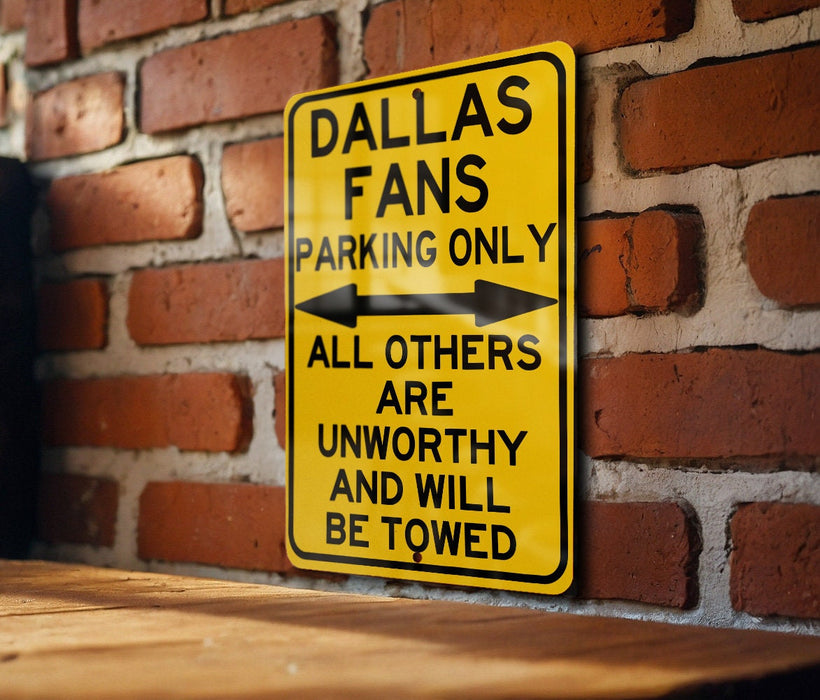 a yellow street sign on a brick wall