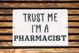 a sign that says trust me i'm a pharmacist