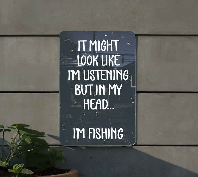 a sign that says it might look like i'm listening but in my head