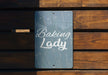 a sign that says baking lady on it